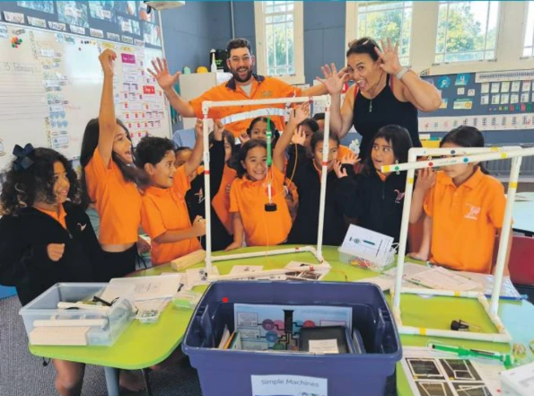 Children and adults exploring science activities with classroom resources